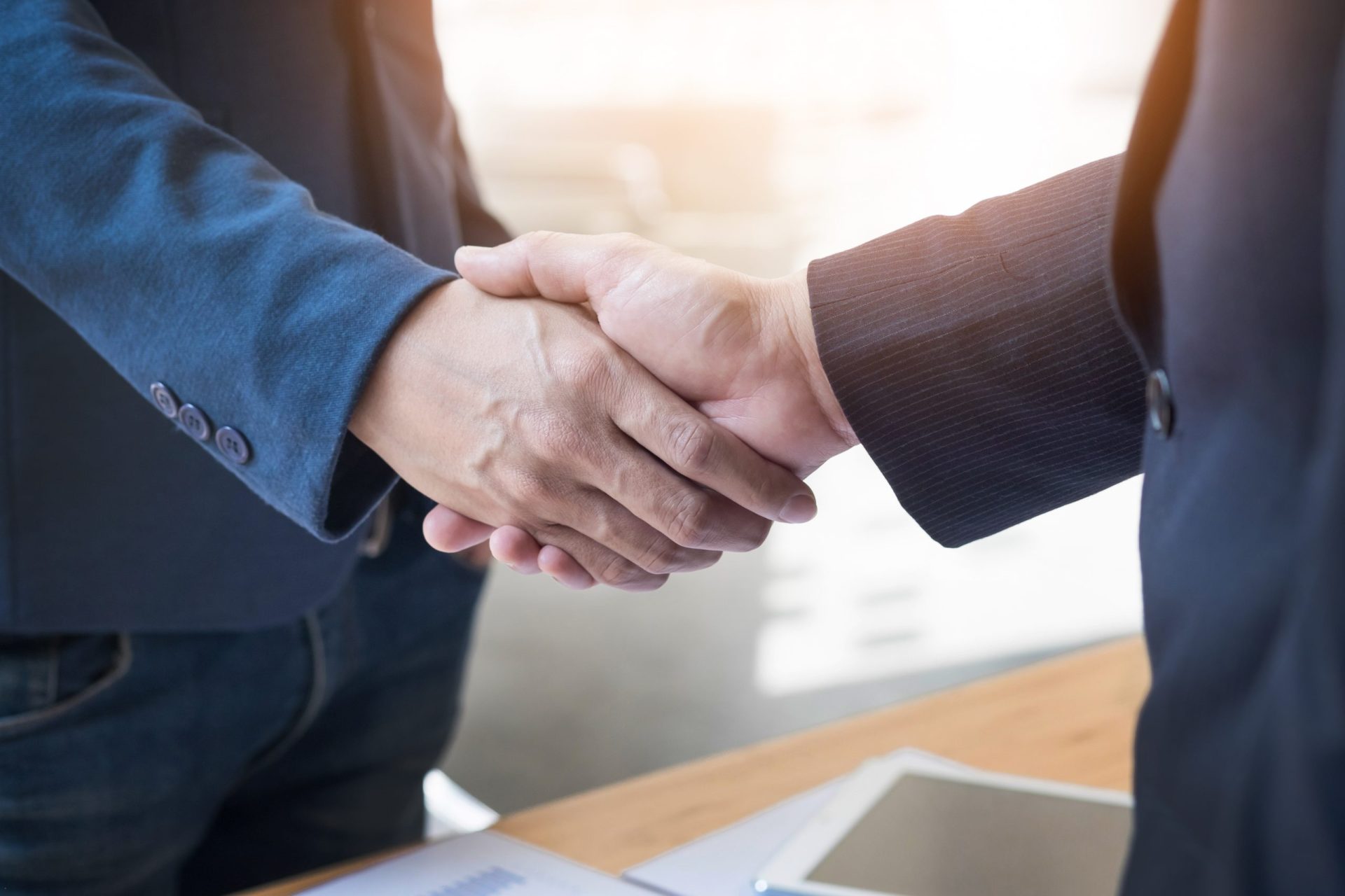 two confident business man shaking hands during meeting office success dealing greeting partner concept scaled - Aides locales -